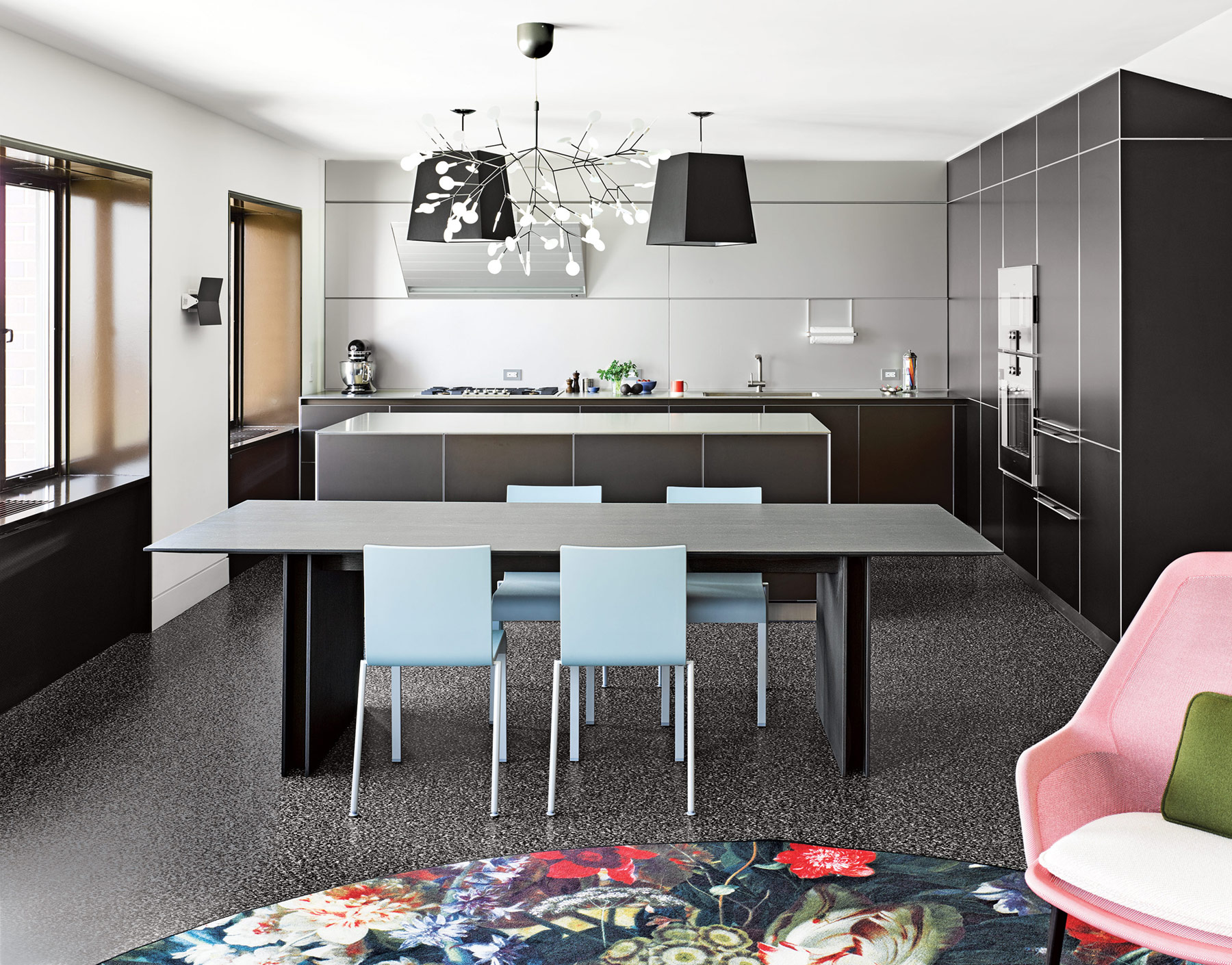 eclectic speckled black floor and black bulthaup kitchen construction